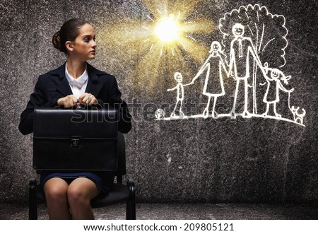 Young upset businesswoman sitting on chair with briefcase