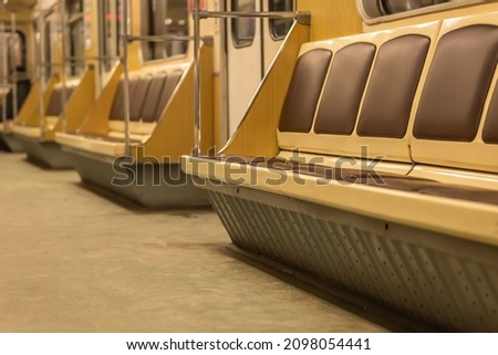 photo of the interior in a subway car. places for the transportation of passengers. background picture. space for printing text. selective focus.