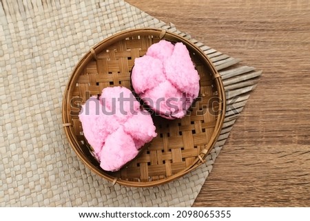 Kue Mangkok (Chinese fa gao) known as fortune cake, usually for Chinese New Year. Made from wheat flour and rice flour. Served on bamboo plate on wooden background. Selected focus image. Royalty-Free Stock Photo #2098065355