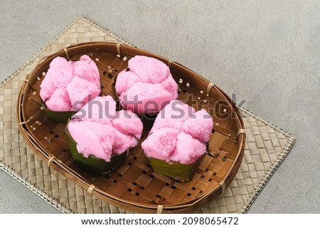 Kue Mangkok (Chinese fa gao) known as fortune cake, usually for Chinese New Year. Made from wheat flour and rice flour. Served on bamboo plate on wooden background. Selected focus image. Royalty-Free Stock Photo #2098065472