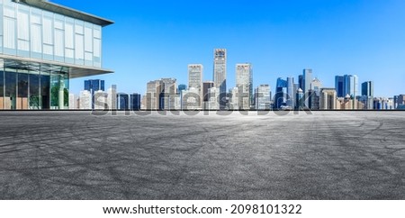 Panoramic skyline and modern commercial office buildings with empty road in Beijing, China.