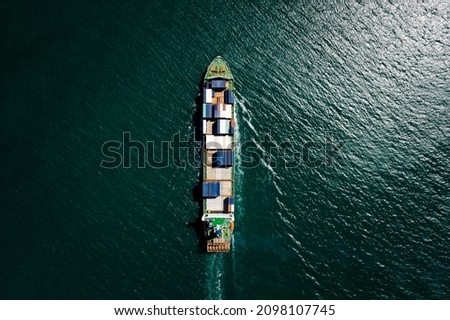 Aerial top view container ship sailing on the green sea full speed container for logistics, import export, business and Industry by shipping or transportation Worldwide ocean freight 