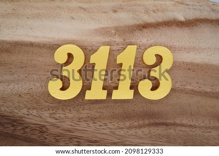 Golden Arabic numerals 3113 on a dark brown to white wood grain background.