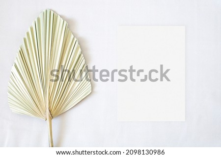 Top view mockup wedding card with dry grass on the beige background