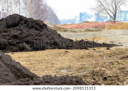 the final stage of construction - greening areas requires black soil, selective focus