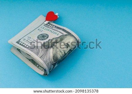 100 dollar bills on blue background . Close up , copy space 