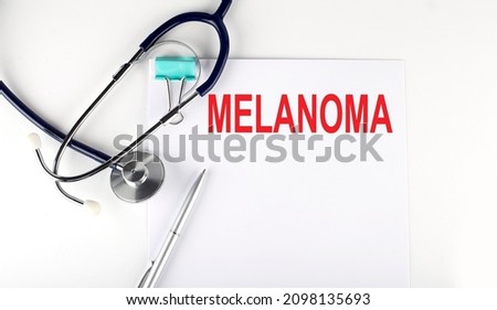 MELANOMA text written on the paper with stethoscope. Medical concept.