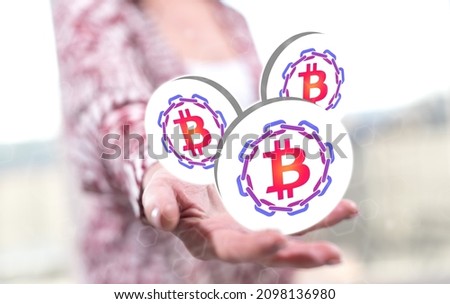 Blockchain concept above the hand of a woman in background