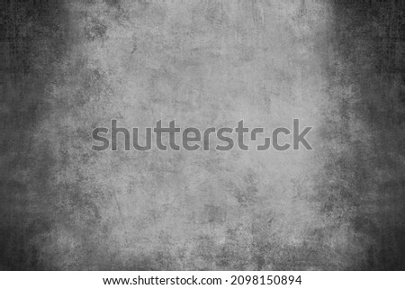 Black and white grungy backdrop with dark vignette borders and distressed texture 