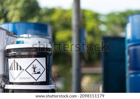 "Environmentally hazardous" placard chemical warning sign on the chemical box which is keep at chemical storage area. Industrial sign and object photo. Close-up and selective focus.