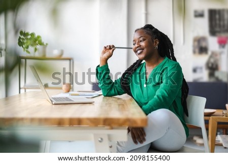 Young adult female professional working in a modern office
