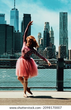 redhead young dancer posing at city street in front of Downton New York City Financial District