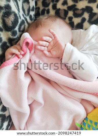 Cute baby sleeping face covered hidden under duvet Royalty-Free Stock Photo #2098247419