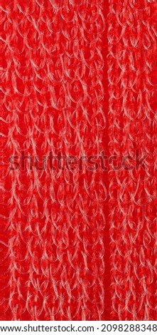 closeup, background, texture, large long vertical banner. heterogeneous surface structure bright saturated red sponge for washing dishes, kitchen, bath. full depth of field. high resolution photo