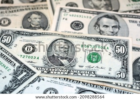 Selective focus of old United States Of America money banknotes, pile of vintage retro American dollars bills of different values, 50 dollars, 10, 5, 2 and 1 dollar, background of American money
