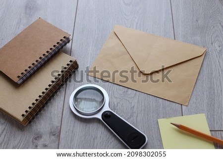 Top view photograph of craft envelope and notebook. write letter. on wood table with copy space