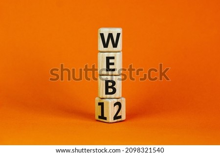 WEB 1 or 2 symbol. Turned a wooden cube and changed words WEB 1 to WEB 2. Beautiful orange table, orange background, copy space. Business, technology and WEB 1 or 2 concept.