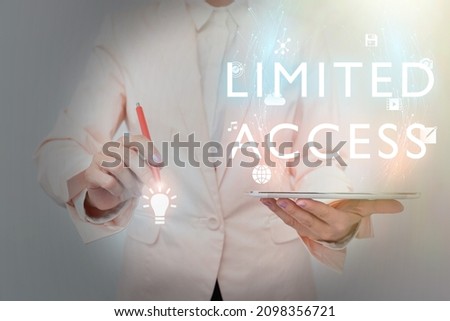 Conceptual caption Limited Access. Business approach Having access restricted to a quite small number of points Business Woman Using Phone While Presenting New Futuristic Virtual Display.