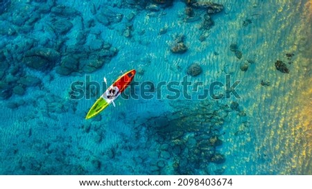 Aerial view of a kayak in the blue sea .Woman kayaking She does water sports activities. Royalty-Free Stock Photo #2098403674