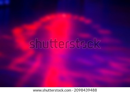 Blurred dark purple background with bright pink spots.