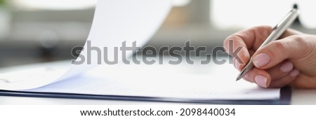 Woman hand signing documents on clipboard with ballpoint pen closeup. Conclusion of contracts and transactions concept Royalty-Free Stock Photo #2098440034