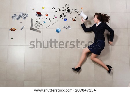 Funny businesswoman lying on floor businesswoman holding megaphone