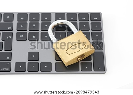 Golden metallic lockpad on the black keyboard.
