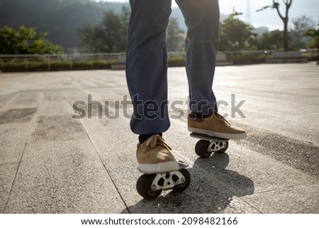 Freeline skateboarder legs skateboarding at city