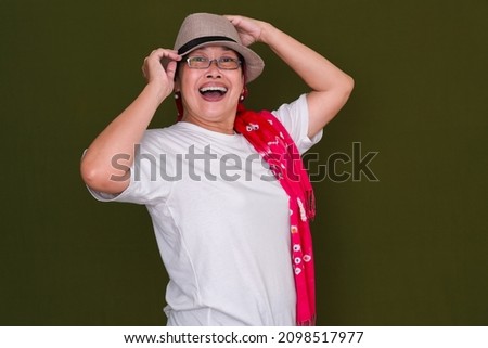 woman in casual clothes and hat looking very excited