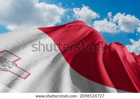 malta flag fitting on wind and blue sky Royalty-Free Stock Photo #2098524727