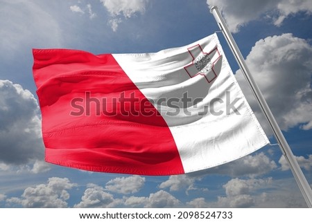 malta flag fitting on wind and blue sky