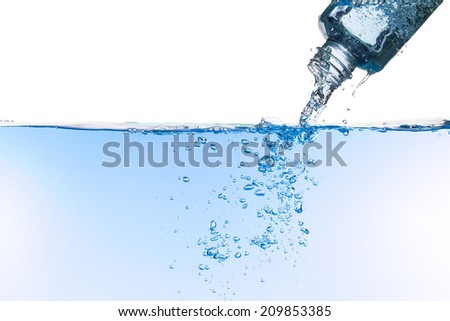 Water flows out of a bottle, creating bubbles against a white background