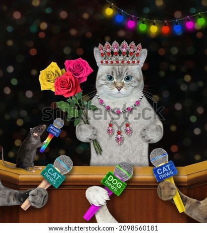 An ashen famous cat in a diadem and a pendant with a bouquet of  roses gives an interview to the press.