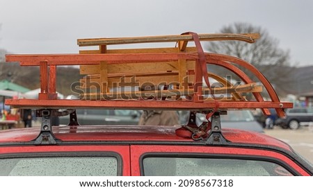 Two Wooden Sleds at Car Roof Rack Transport