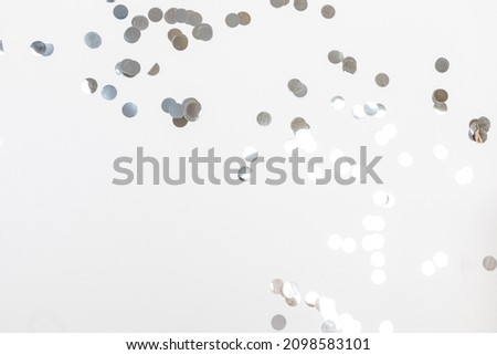 round silver confetti on white background flat lay text place - Image 