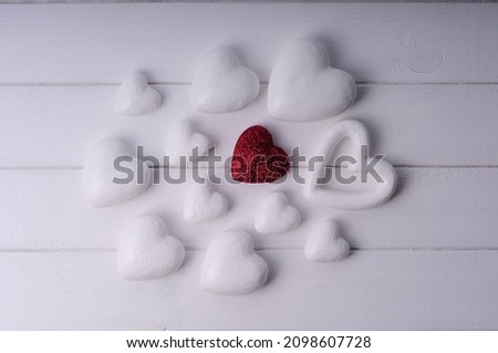White and red heart on a wooden table. Valentine's day.