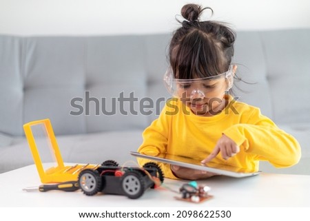 Asia students learn at home in coding robot cars and electronic board cables in STEM, STEAM, mathematics engineering science technology computer code in robotics for kids concept. Royalty-Free Stock Photo #2098622530