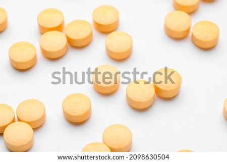 Many vitamin A pills scattered on white background, closeup