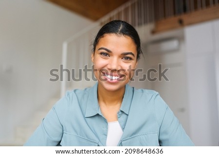 Close-up portrait of happy young woman looking at the camera and smiling. Concept of video call, online communication on the laptop. Webcam view, video chat Royalty-Free Stock Photo #2098648636