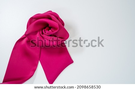 pink rose on a satin cloth with smooth white background