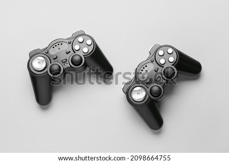Modern joysticks on grey background