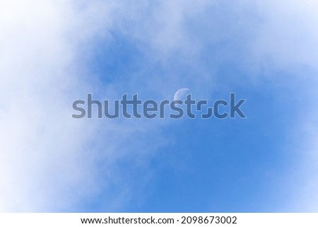 Moon with clouds on a blue background