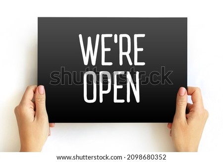 We're Open text on card, concept background