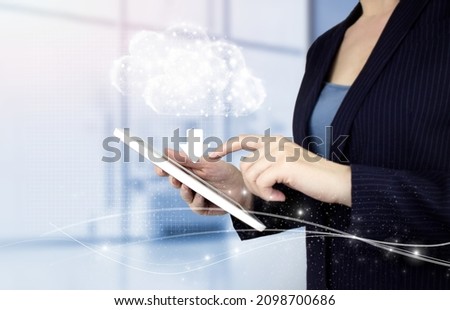 Download Data Storage Business Technology Network Concept. Hand touch white tablet with digital hologram cloud, download, data sign on light blurred back. Update Software Computer Program Upgrade.