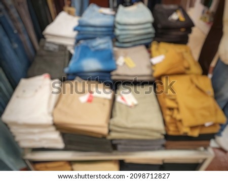 Various types of pants available in supermarkets.  The abstract background is blurry.