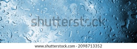 Water drops on glass, raindrops, texture, banner and background, drops in blue, turquoise