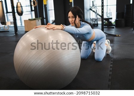 Fitness woman exercising with a fitness ball
