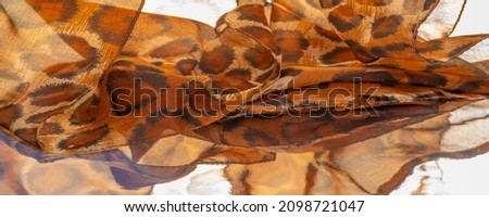 Light fine silk fabric, cheetah skin, brown. African savanna theme. Background texture, pattern