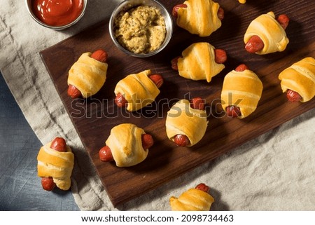 Homemade Pigs in a Blanket with Mustard and Ketchup Royalty-Free Stock Photo #2098734463