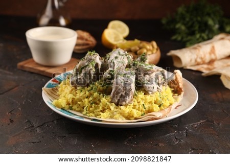 mansaf, Jordanian national dish on rustic background
 Royalty-Free Stock Photo #2098821847